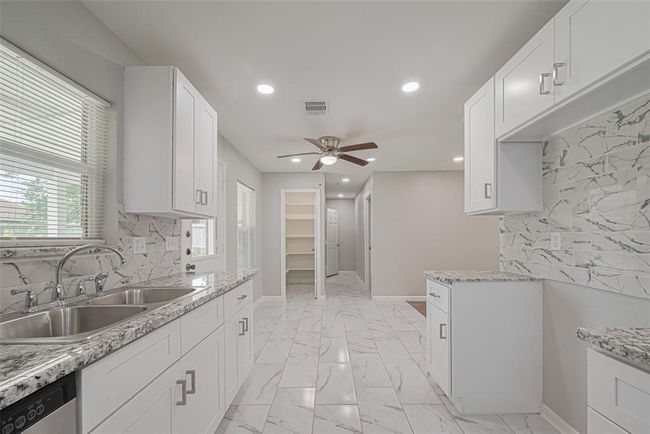 From the kitchen, a clear view of the dining space and pantry emphasizes the practical and connected layout. | Image 11