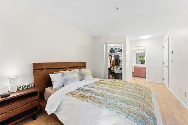 Bedroom with light wood-style floors, a spacious closet, connected bathroom, a closet, and baseboards | Image 15
