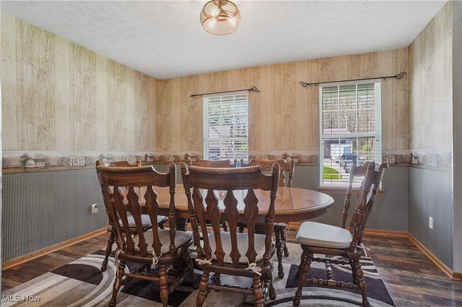 Dining space featuring a textured ceiling, wood finished floors, and plenty of natural light | Image 22