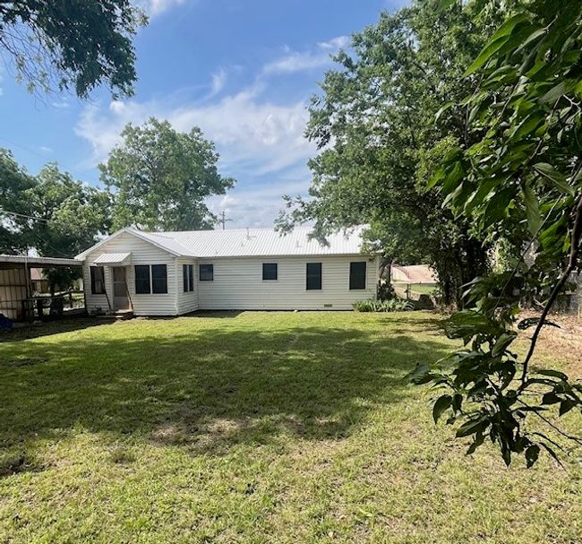 Back of property with a lawn and metal roof | Image 9