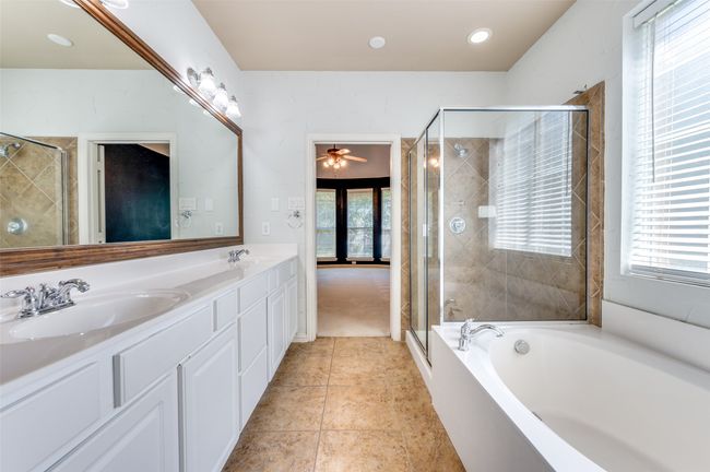 Primary Bathroom with double vanity, a separate shower, garden tub, recessed lighting, and tile patterned floors | Image 13