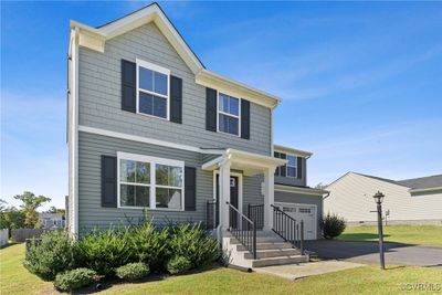 View of front of home featuring a garage and a front lawn | Image 1