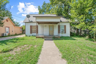 View of front of property with covered porch, cooling unit, and a front yard | Image 1