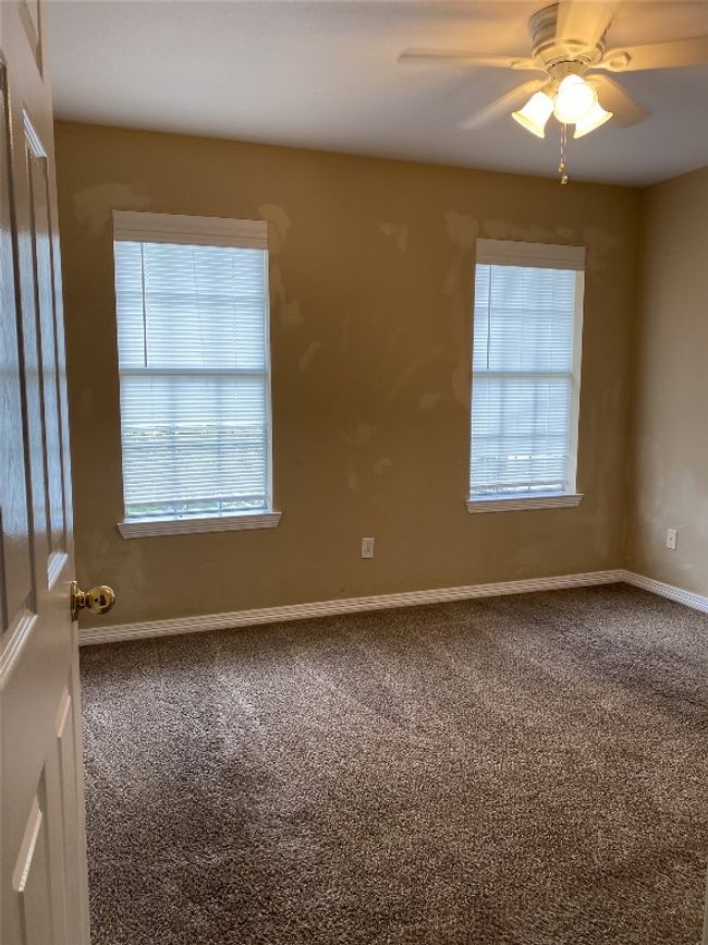Empty room featuring carpet floors, plenty of natural light, and ceiling fan | Image 4