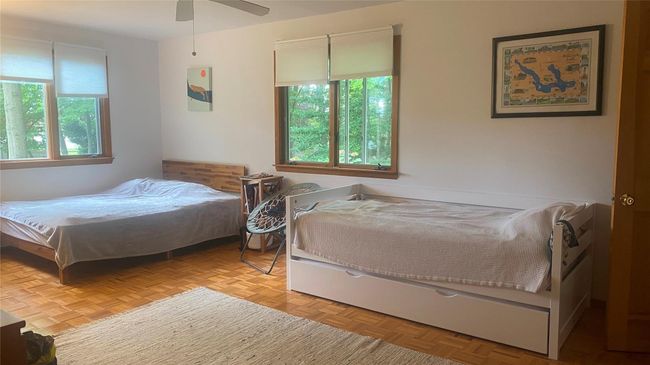 Bedroom with hardwood floors, 2 walking closets, ceiling fan | Image 14