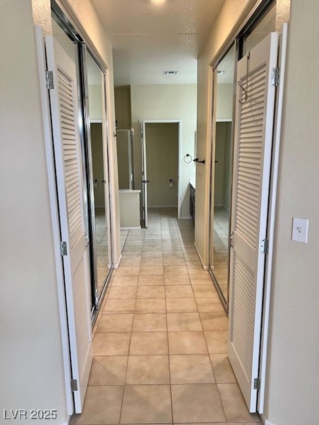 Hallway with light tile patterned floors and attic access | Image 19