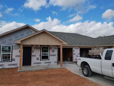 Property in mid-construction featuring covered porch and a garage | Image 1