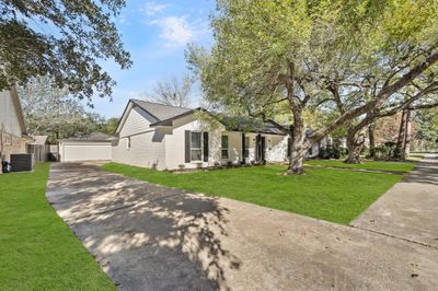 This home boasts a long driveway. | Image 3