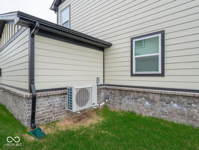 view of side of property with brick siding and ac unit | Image 49