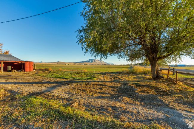 View of SW pasture featuring a mountain view and a rural view and a livestock shelter | Image 8