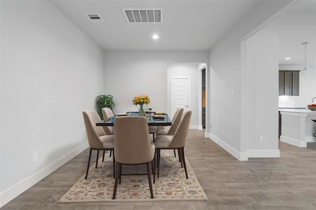 Make memories gathered around the table with your family and friends! This dining room features high ceilings, custom paint, and gorgeous flooring. | Image 6
