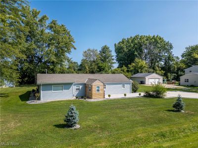 View of front facade with a garage and a front yard | Image 2