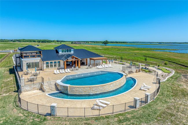 Community pool featuring a patio area, a water view, and observation deck | Image 19