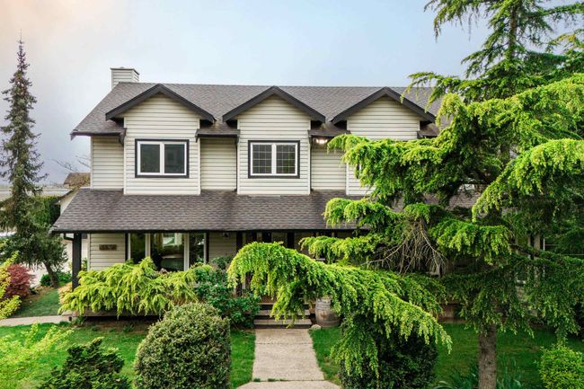 View of front of property featuring a shingled roof and a chimney | Image 10