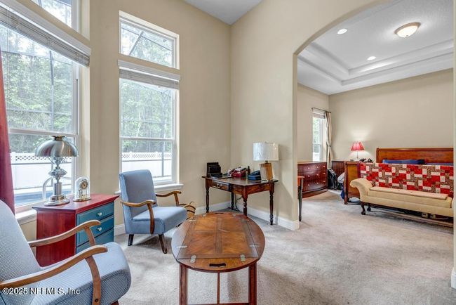 Sitting area with arched entry into primary suite | Image 32