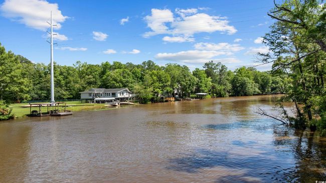 Water view featuring a heavily wooded area | Image 34