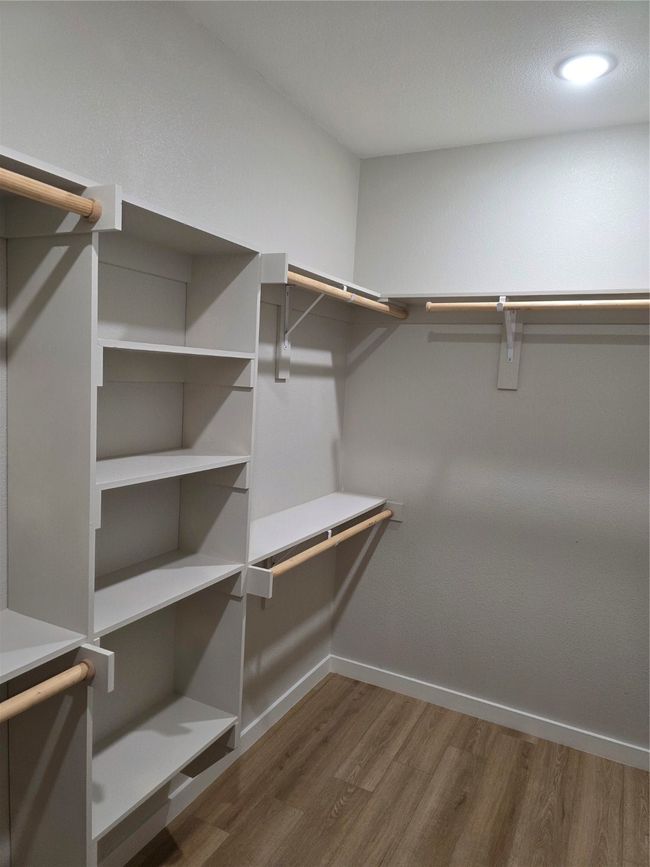 Spacious closet featuring wood finished floors | Image 6
