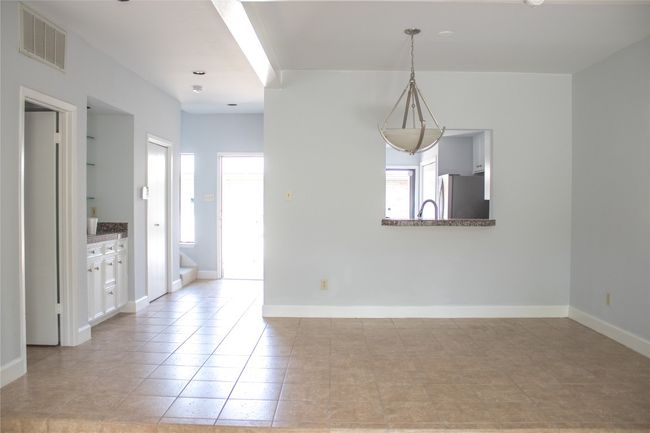 Unfurnished dining area with baseboards, visible vents, and light tile patterned floors | Image 4