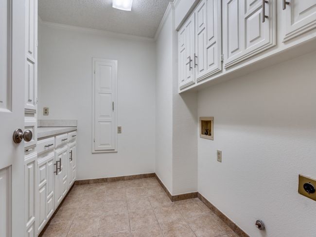 Utility room on first floor has awesome storage and counter top space to work! | Image 32