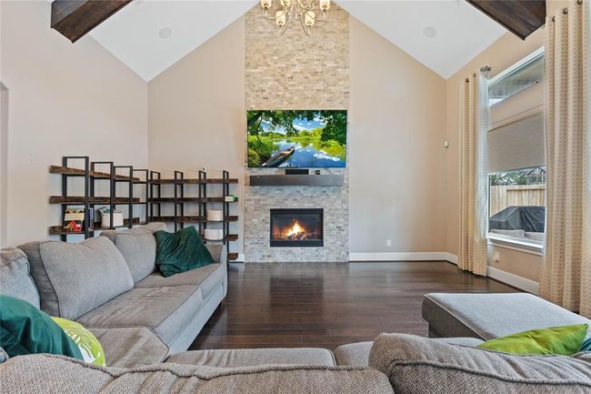 Fireplace serves a perfect focal point through this main living space. | Image 11