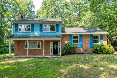 Split level home featuring a front lawn | Image 1