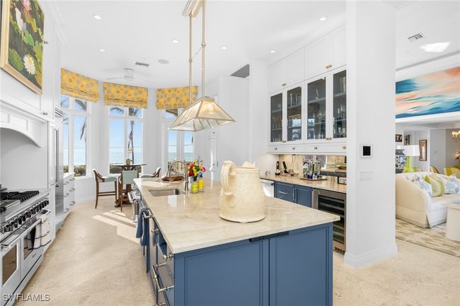 Chef's kitchen featuring Viking double oven gas range, , bar area with beverage drawers, wine cooler, custom cabinetry, breakfast nook | Image 18