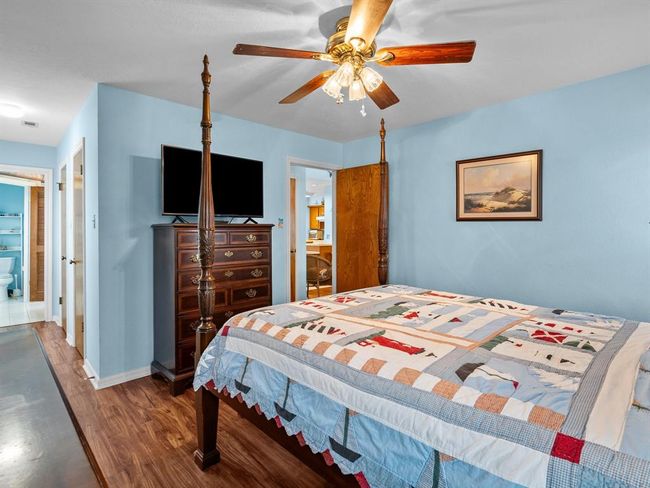 Primary bedroom with view into the en suite bathroom | Image 15