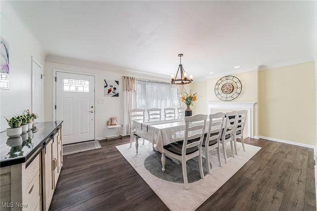 Dining space featuring baseboards, recessed lighting, dark wood-type flooring, and a chandelier | Image 9