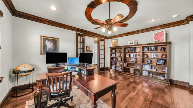 Office space with crown molding, wood finished floors, ceiling fan, and french doors | Image 5