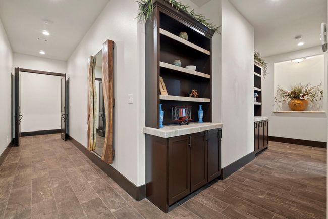Hallway, double door in front leads to primary bedroom. To your right in order is the laundry room. and two secondary bedrooms with Jack and Jill bathroom. | Image 24