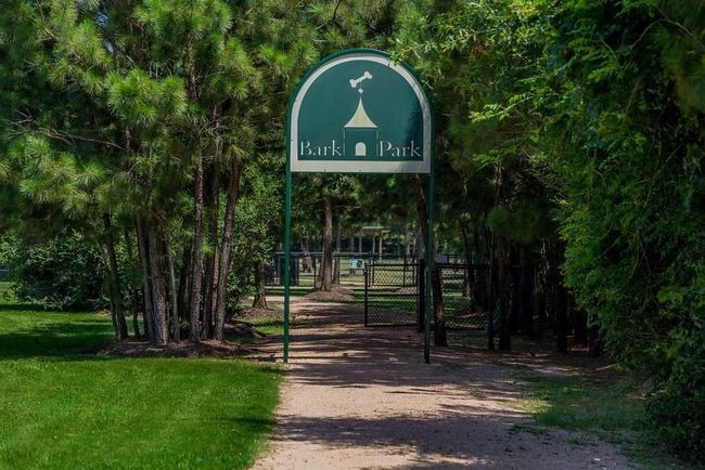 The BARK PARK where our 4-legged family members enjoy a 2.5-acre fenced dog park featuring separate areas for small & large dogs, trails, drinking fountains for pets and shaded seating for their owners. | Image 50