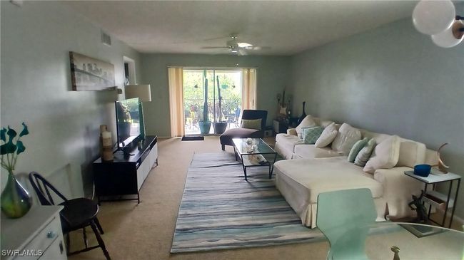 Living room with ceiling fan and light carpet | Image 11