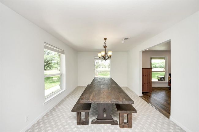Located just off the kitchen, this dining room easily fits a 9' table—perfect for hosting family dinners and holiday gatherings. | Image 15