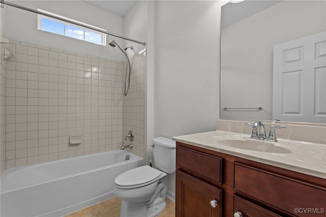 Bathroom featuring vanity, shower / washtub combination, and tile patterned floors | Image 26