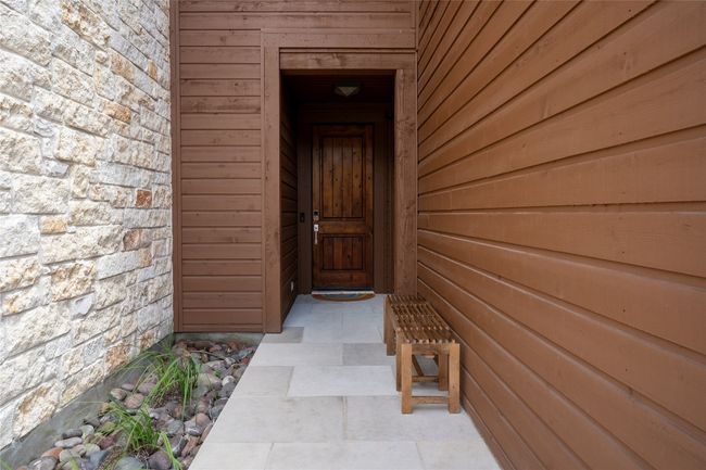Doorway to property featuring stone siding | Image 4