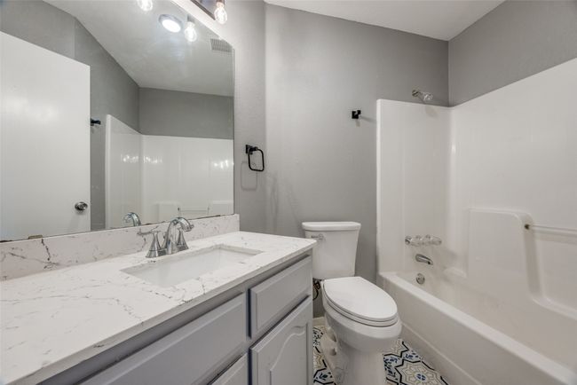 Full bathroom featuring vanity and bathtub / shower combination | Image 12