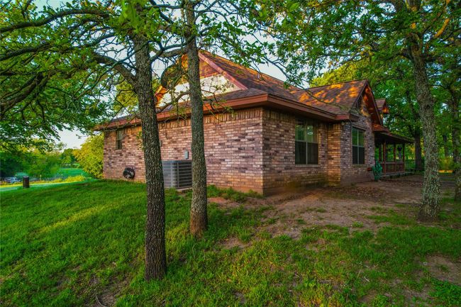 View of property exterior with a lawn and central air condition unit | Image 24