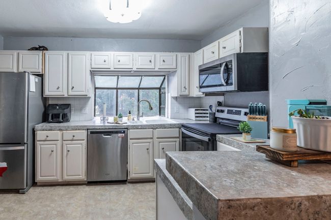 Spacious kitchen with newer appliances. Refridgerator will stay. | Image 12