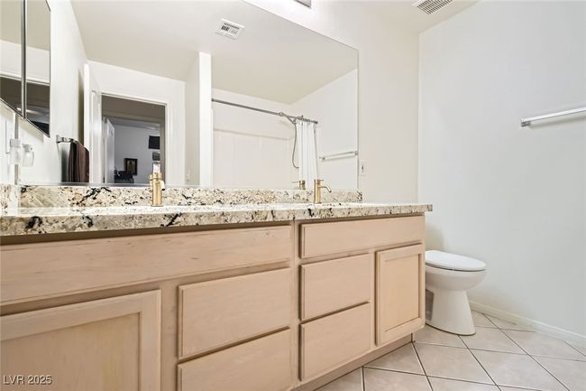 Bathroom featuring tile patterned flooring, double vanity, toilet, baseboards, and a shower with shower curtain | Image 29