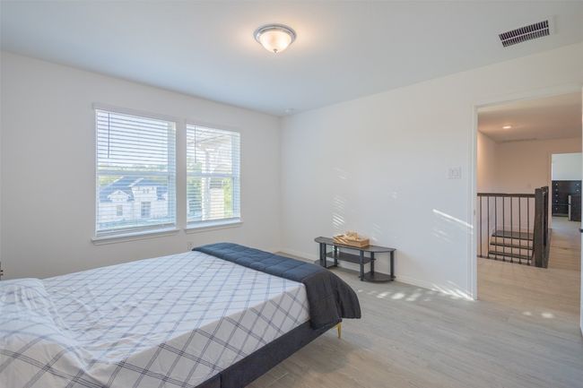 Another angle of the bedroom and the natural light that pours in from the windows. | Image 25