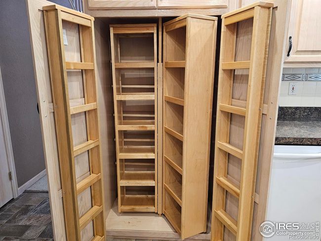 Pantry located beside the dishwasher | Image 12