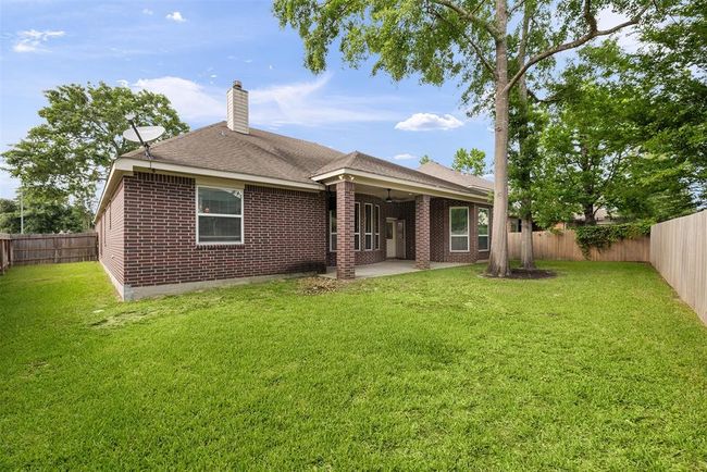From the spacious backyard, you’ll appreciate the inviting appeal of the home, with its freshly updated exterior paint and a welcoming covered patio. The newly replaced fence (2024) provides both privacy and a clean, modern look, making this outdoor space perfect for both relaxation and gatherings. | Image 25