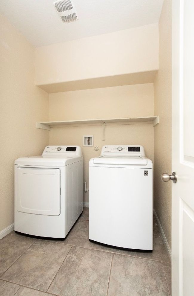 Washroom featuring separate washer and dryer, baseboards, and light tile patterned flooring | Image 22