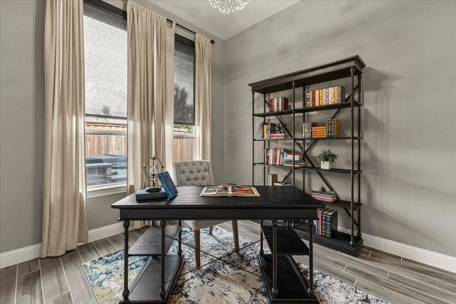 Office area with wood tiled floors and a chandelier | Image 20