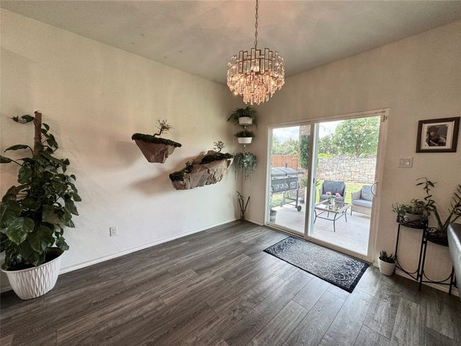 Unfurnished dining area featuring wood finished floors and a chandelier | Image 14