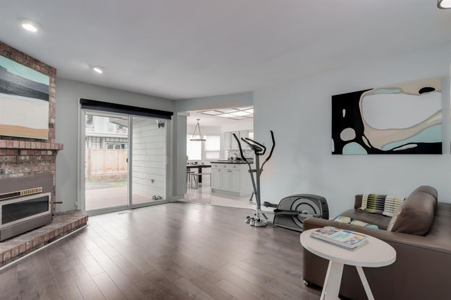 Workout room featuring a fireplace and wood finished floors | Image 12