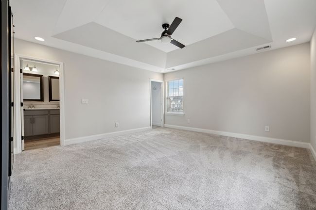 Primary bedroom with his and hers closets and vaulted ceiling | Image 20