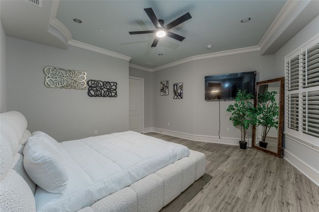 Bedroom featuring wood finished floors, ornamental molding, and ceiling fan | Image 28