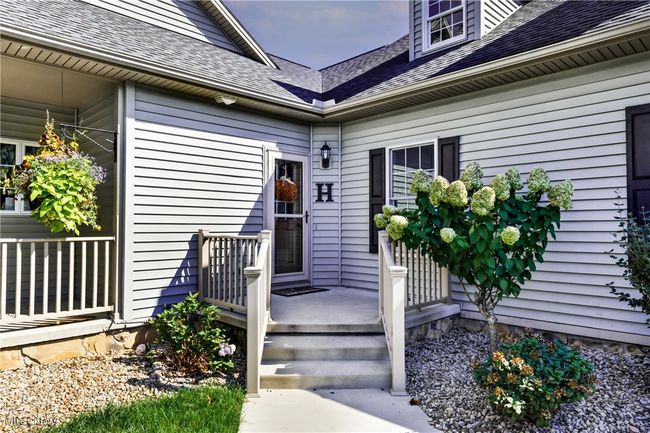 View of exterior entry featuring covered porch and a shingled roof | Image 10