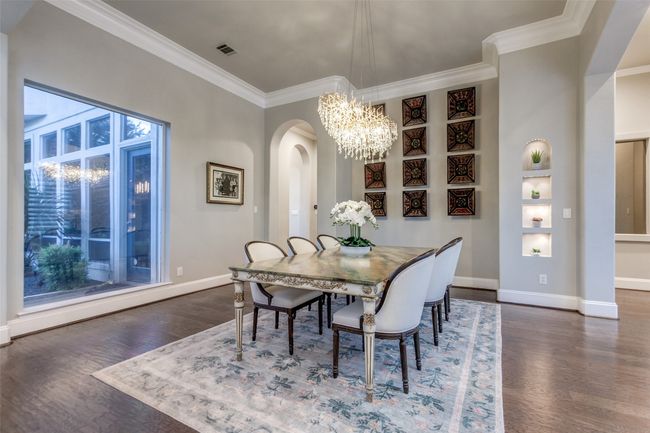 Another view of the dining room, with a series of lit inset niches, and a large picture window, which looks fantastic at night with the back yard illumination. | Image 8